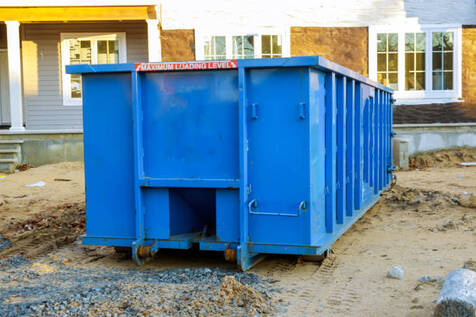 Blue dumpster at a new house construction site in Norwalk, CT.