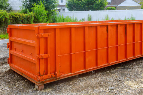 An orange dumpster in a Norwalk, CT residential yard.