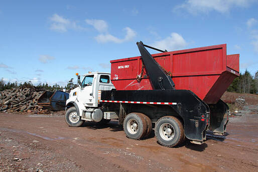 Red dumpster transporter at a junk yard in Norwalk, CT.