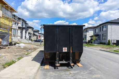 A dumpster rental in the street of a new residential house development in Norwalk, CT.