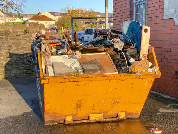 A yellow dumpster at an apartment complex in Norwalk, CT.